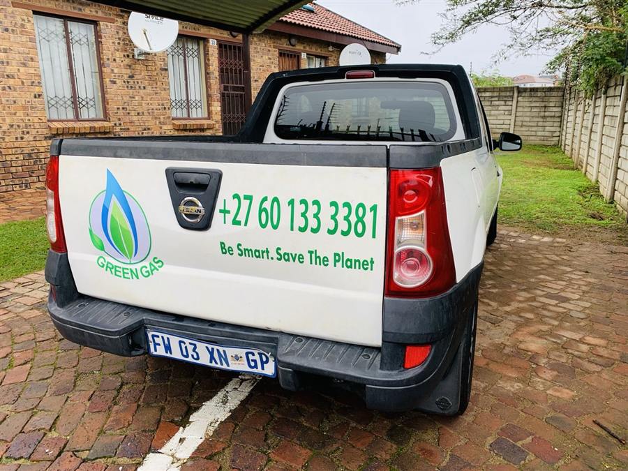 Green Gas branded vehicle showing phone number and slogan