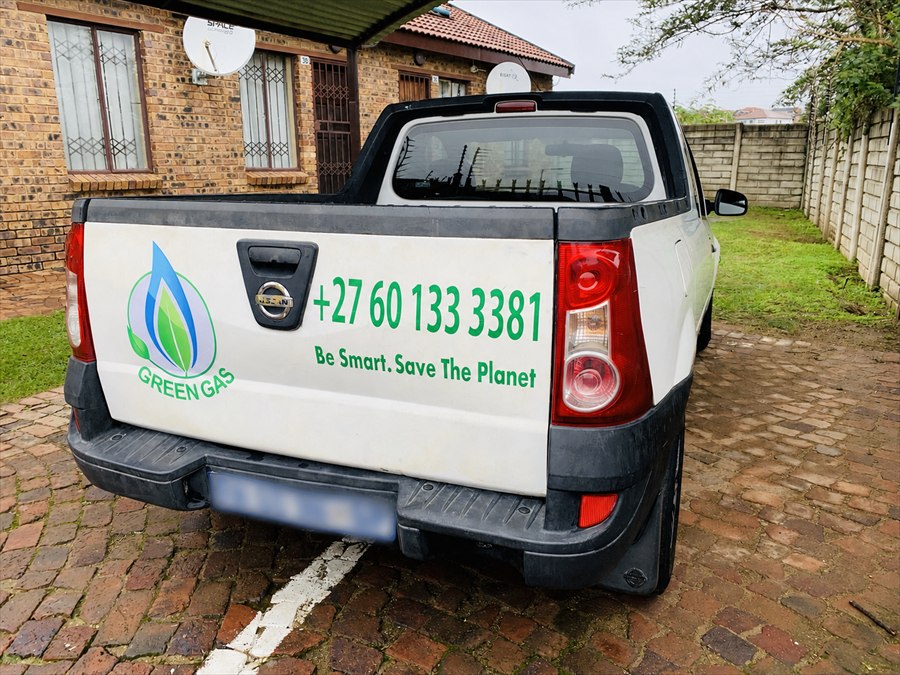 Green Gas branded vehicle showing phone number and slogan